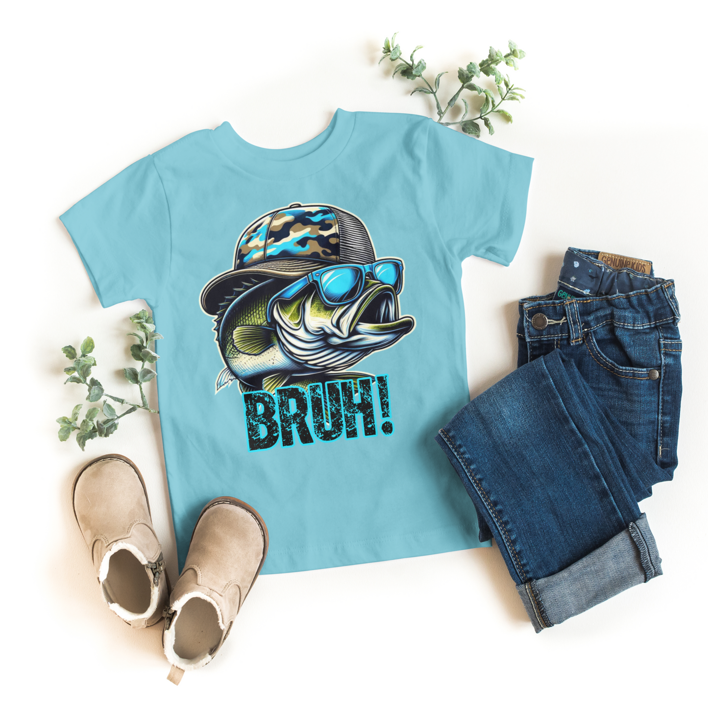 Light blue t-shirt with fish graphic and 'BRUH!' text, paired with jeans and boots on a white background.